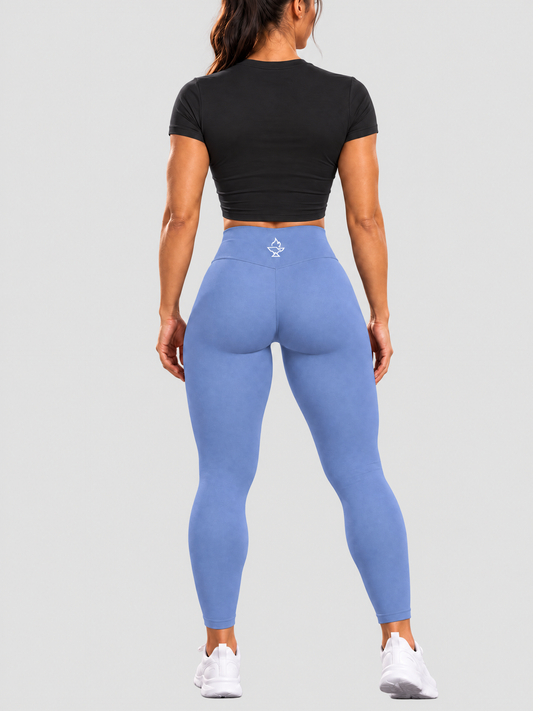 ForgeForm Seamless Leggings in Blue on a model, back view showing the waistband logo